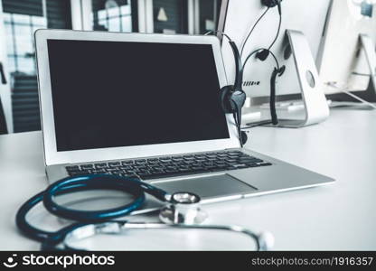 Headset and doctor equipment at clinic ready for actively support for patient by online video call . Concept of telehealth and telemedicine service .. Headset and doctor equipment at clinic ready for actively support for patient