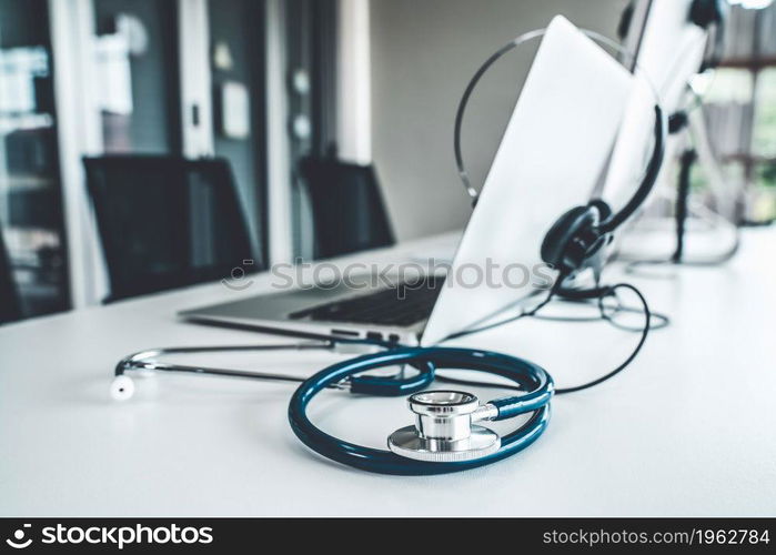 Headset and doctor equipment at clinic ready for actively support for patient by online video call . Concept of telehealth and telemedicine service .. Headset and doctor equipment at clinic ready for actively support for patient