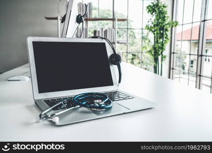 Headset and doctor equipment at clinic ready for actively support for patient by online video call . Concept of telehealth and telemedicine service .. Headset and doctor equipment at clinic ready for actively support for patient