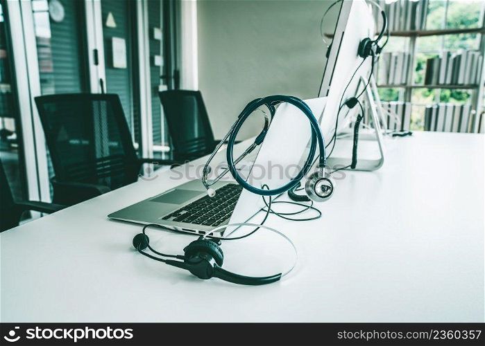 Headset and doctor equipment at clinic ready for actively support for patient by online video call . Concept of telehealth and telemedicine service .. Headset and doctor equipment at clinic ready for actively support for patient