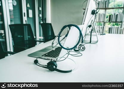 Headset and doctor equipment at clinic ready for actively support for patient by online video call . Concept of telehealth and telemedicine service .. Headset and doctor equipment at clinic ready for actively support for patient