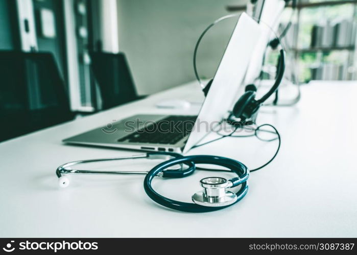 Headset and doctor equipment at clinic ready for actively support for patient by online video call . Concept of telehealth and telemedicine service .. Headset and doctor equipment at clinic ready for actively support for patient