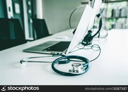 Headset and doctor equipment at clinic ready for actively support for patient by online video call . Concept of telehealth and telemedicine service .. Headset and doctor equipment at clinic ready for actively support for patient