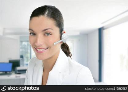 Headset phone business woman dress in white indoor modern office