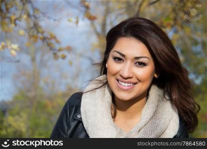 Headshot of a hispanic woman outdoors during a fall day