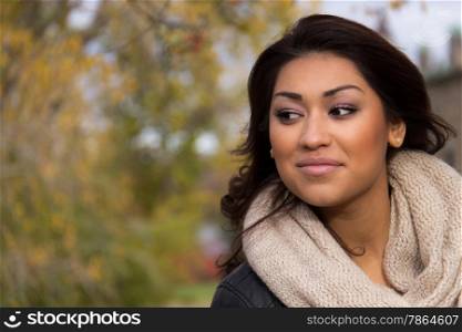 Headshot of a hispanic woman outdoors during a fall day