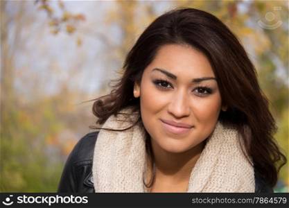 Headshot of a hispanic woman outdoors during an autumn day