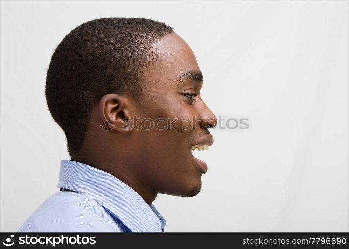 Headshot of a young business professional with his mouth open, side view, isolated on white