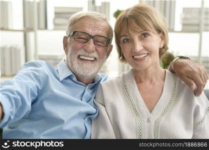 Headshot of Caucasian happy seniors elderly are video calling to family or friends, relax at home, smiling healthy senior retired grandparents concept, headshot