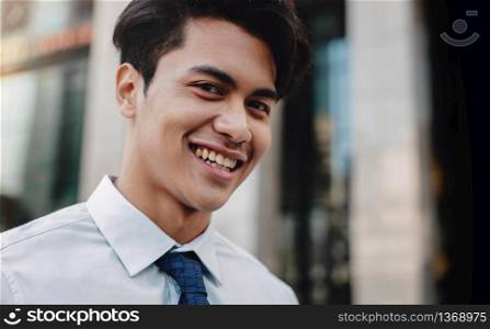 Headshot of Happy Urban Businessman in the City. Young Friendly Man. Looking at the Camera