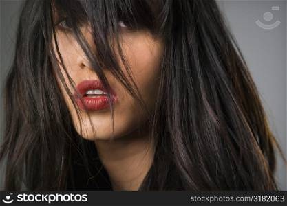 Headshot of pretty young woman with long black hair.