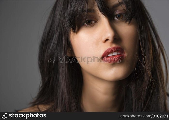 Headshot of pretty young woman with long black hair.
