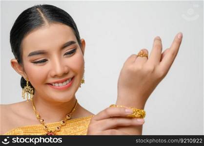 Headshot, portrait Beautiful Asian woman in traditional Thai dress costume smile and pose gracefully on white background, copy space