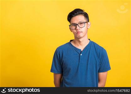 Headshot portrait of Asian young handsome man wear eyeglasses or spectacles, studio short isolated on yellow background with copy space, Fashion male beauty concept