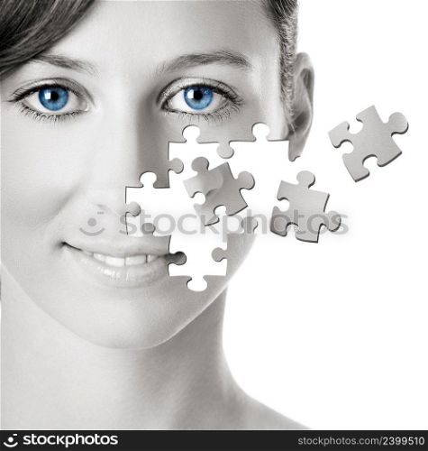 Healh concept image - Beautiful young woman with puzzle pieces