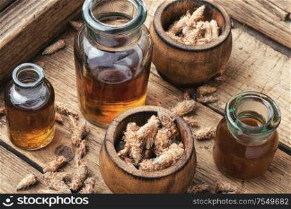 Healing decoction from pine kidneys.Dried pine buds.Herbal medicine. Pine kidneys in folk medicine