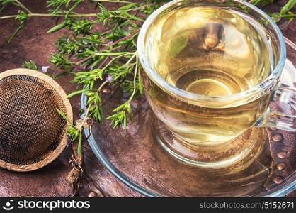 Healing herbal Oregano tea. Herbal tea with Oregano in glass cup in a rustic style