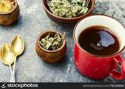 Healing herbs and herbal tea.Glass cup of green tea. Healing herbal tea