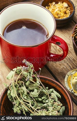 Healing herbs and herbal tea.Glass cup of green tea. Tea on healing herbs.