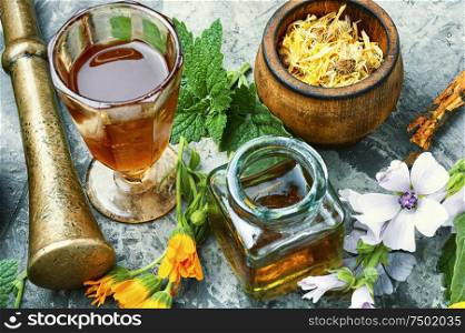 Healing herbs with mortar and bottle of elixir.Alternative or herbal medicine. Set healing herbs