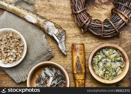 Healing root of elecampane. Medicinal herb in the wooden bowl and inula root