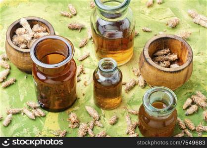 Healing tincture from pine kidneys.Medicinal tincture for colds.Herbal medicine. Bottles of tincture of pine buds