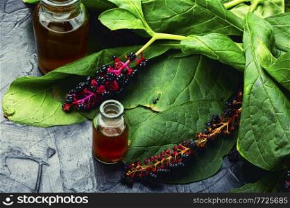 Healing tincture of lakonos,herbal medicine.Wild plant,homeopathic herbs. Inflorescence phytolacca in herbal medicine