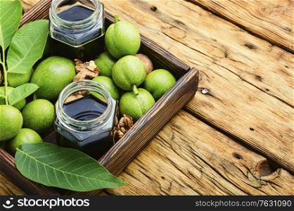 Healing tincture of unripe walnut.Green walnut in herbal medicine.Copy space. Unripe walnut tincture