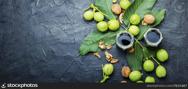 Healing tincture of unripe walnut.Green walnut in herbal medicine.. Unripe walnut tincture