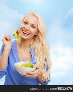 healt, dieting and happiness concept - smiling young woman with green salad