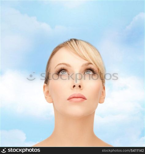 healt, spa and beauty concept - face of beautiful woman with blonde hair looking up