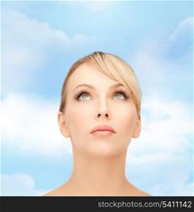 healt, spa and beauty concept - face of beautiful woman with blonde hair looking up