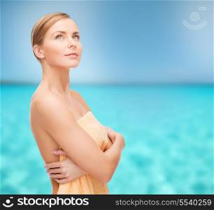 health and beauty concept - beautiful woman in towel looking up