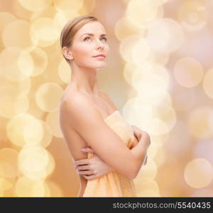 health and beauty concept - beautiful woman in towel looking up