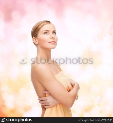 health and beauty concept - beautiful woman in towel looking up