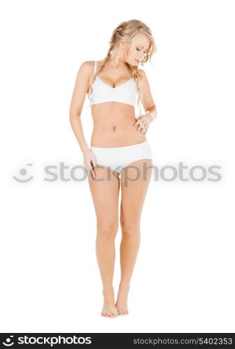 health and beauty concept - beautiful woman in white cotton underwear checking fat level