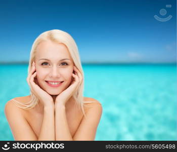 health and beauty concept - beautiful woman touching her face skin