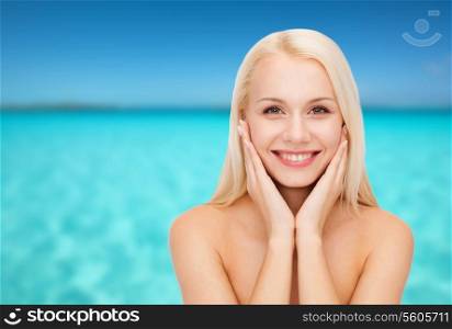 health and beauty concept - beautiful woman touching her face skin