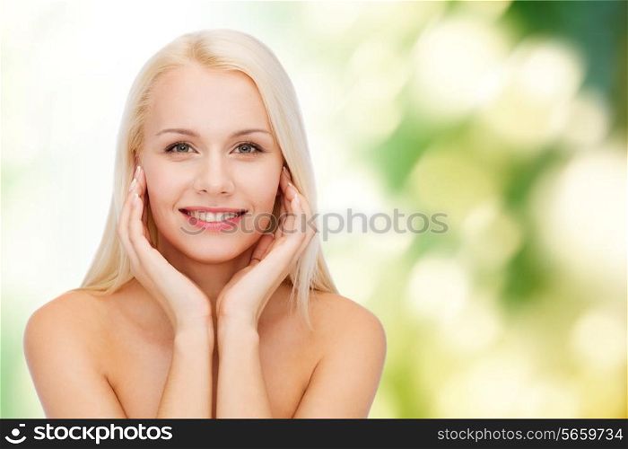 health and beauty concept - beautiful woman touching her face skin