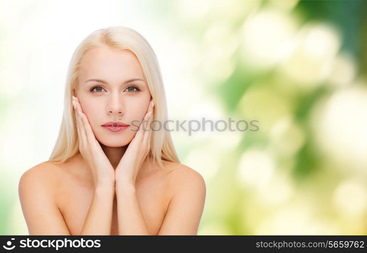 health and beauty concept - beautiful woman touching her face skin