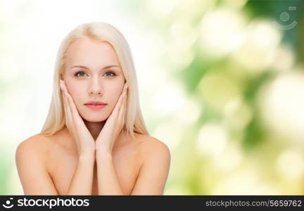 health and beauty concept - beautiful woman touching her face skin