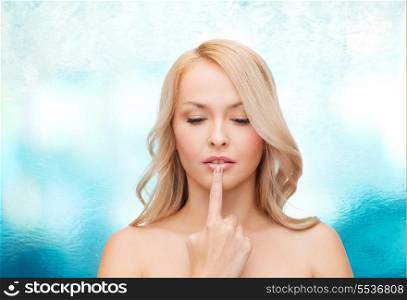 health and beauty concept - beautiful woman touching her lips