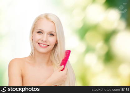 health and beauty concept - beautiful woman with long hair and brush