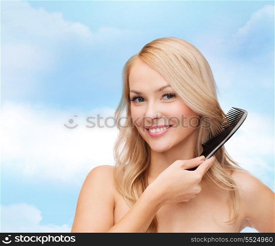 health and beauty concept - beautiful woman with long hair and brush