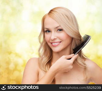 health and beauty concept - beautiful woman with long hair and brush