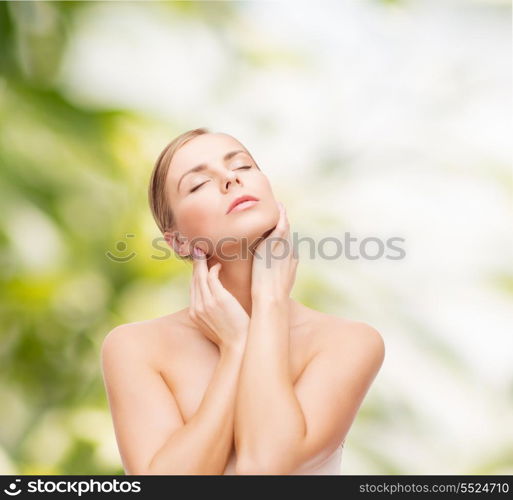 health and beauty concept - beautiful young woman touching her face with closed eyes