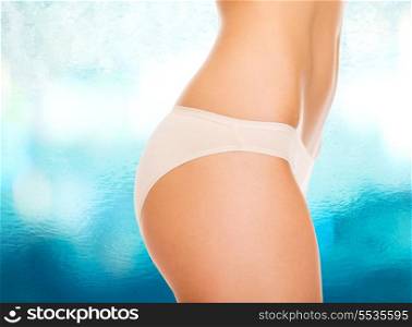 health and beauty concept - close up of woman buttocks in cotton underwear