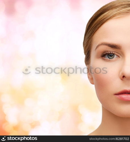 health and beauty concept - closeup of face of beautiful young woman