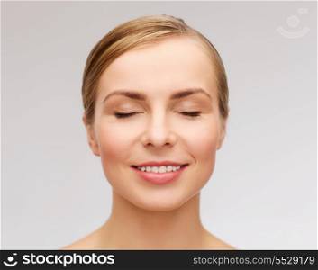 health and beauty concept - closeup of face of beautiful young woman with closed eyes