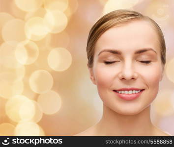 health and beauty concept - closeup of face of beautiful young woman with closed eyes